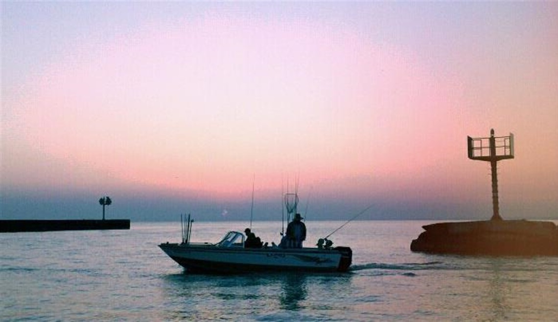 Fishing Boat at the mouth of the Vermilion River with fisherman and fishing poles