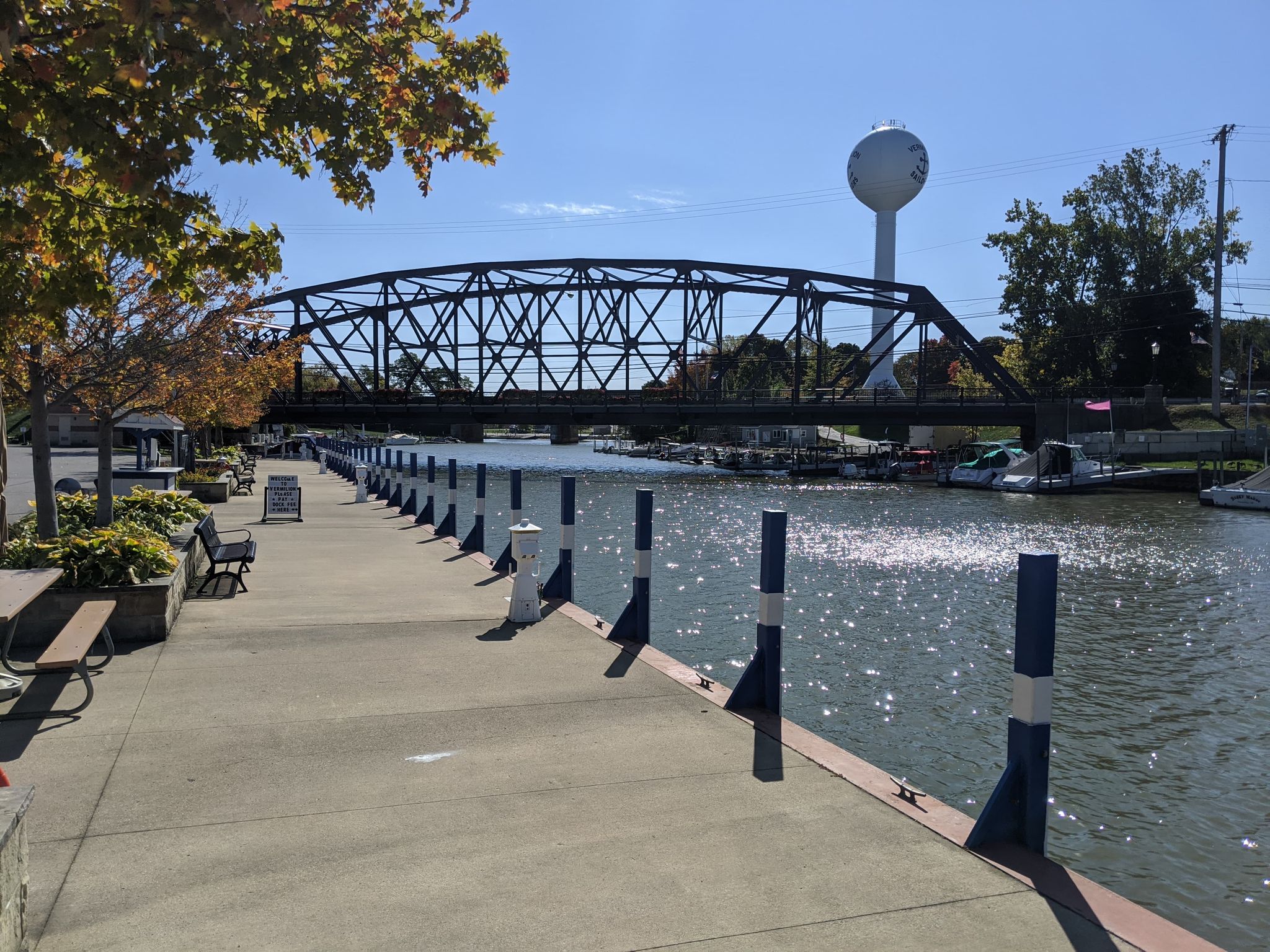 bridge river boat dock and water tower on a sunny day