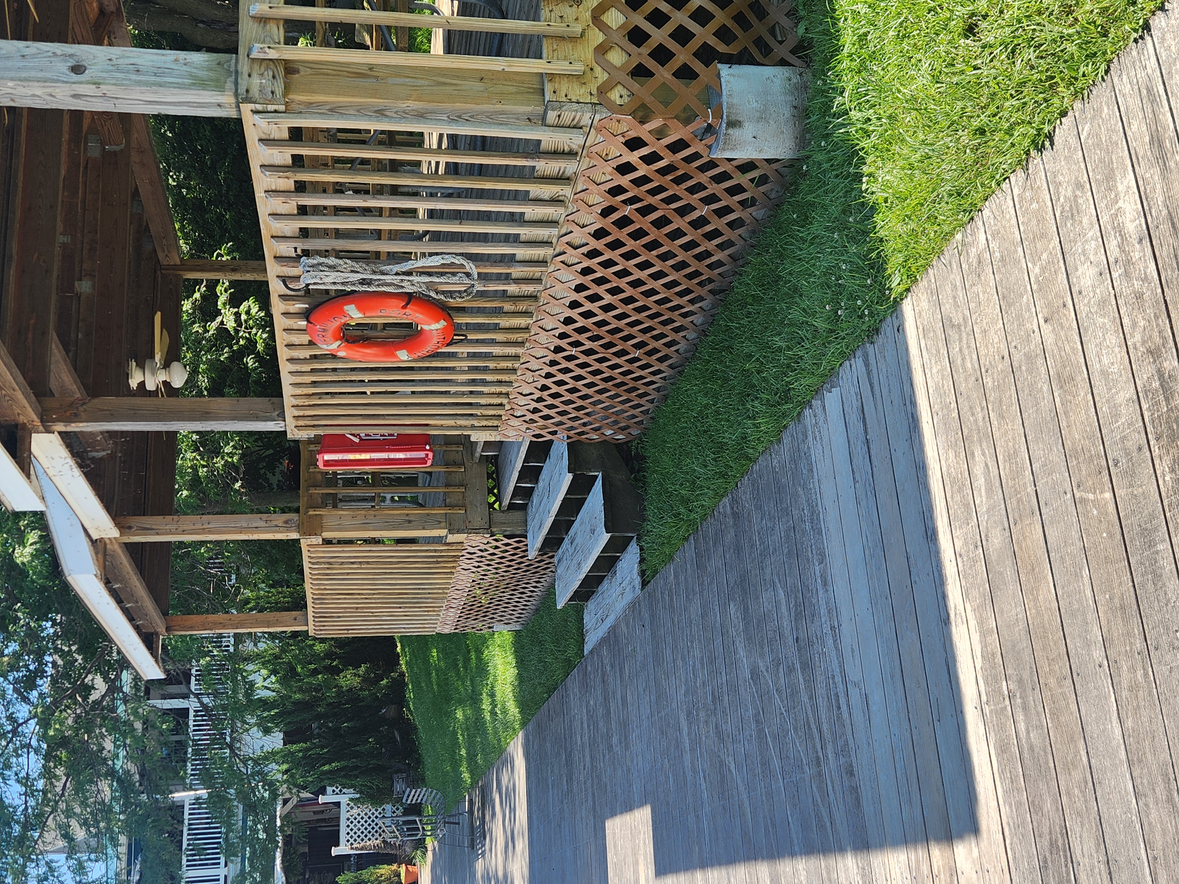 wood shelter with orange llfe floats hanging on it