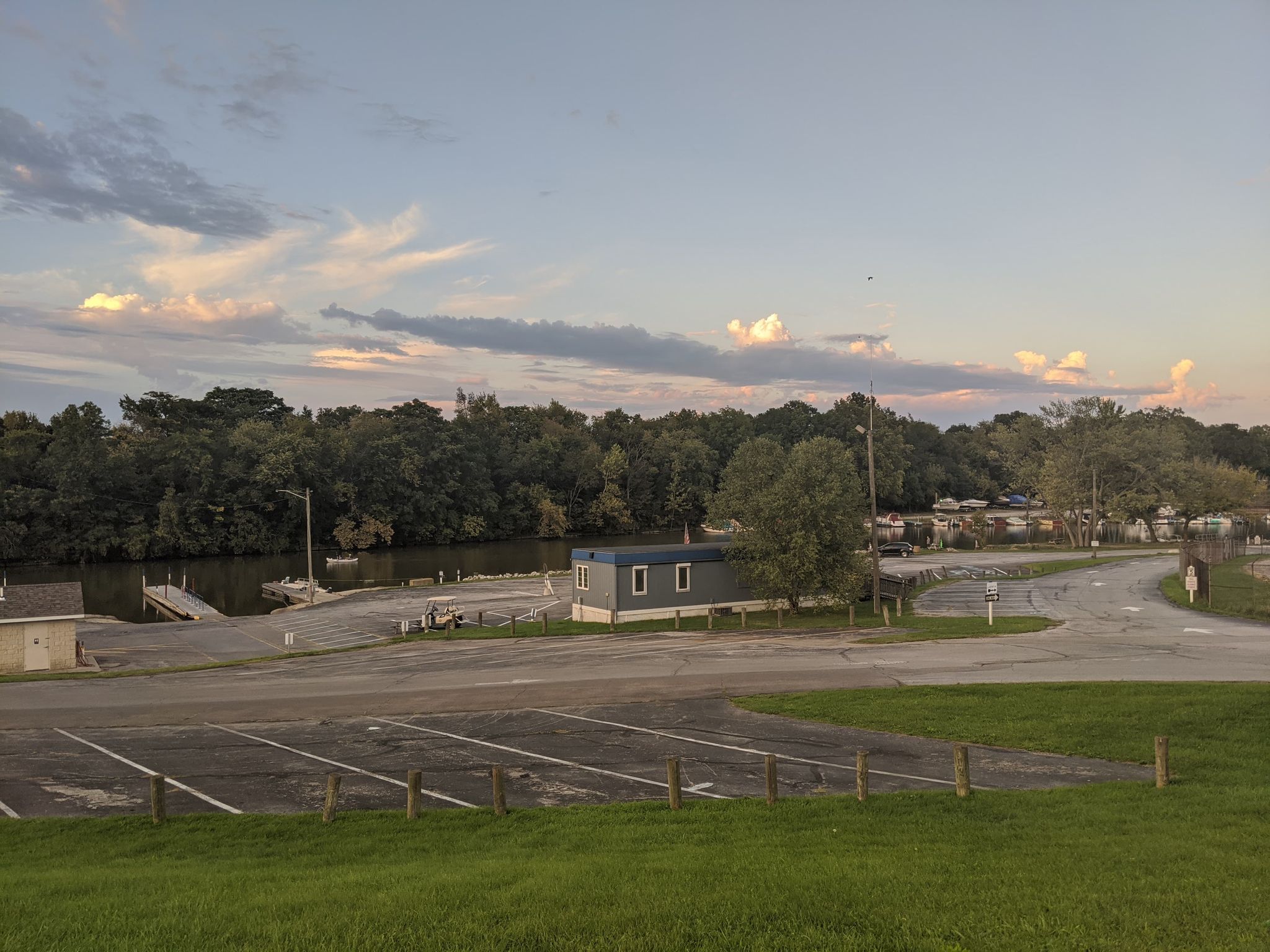 Parking Lot and Trailer and public boat ramp along with view of river and the boat ramp
